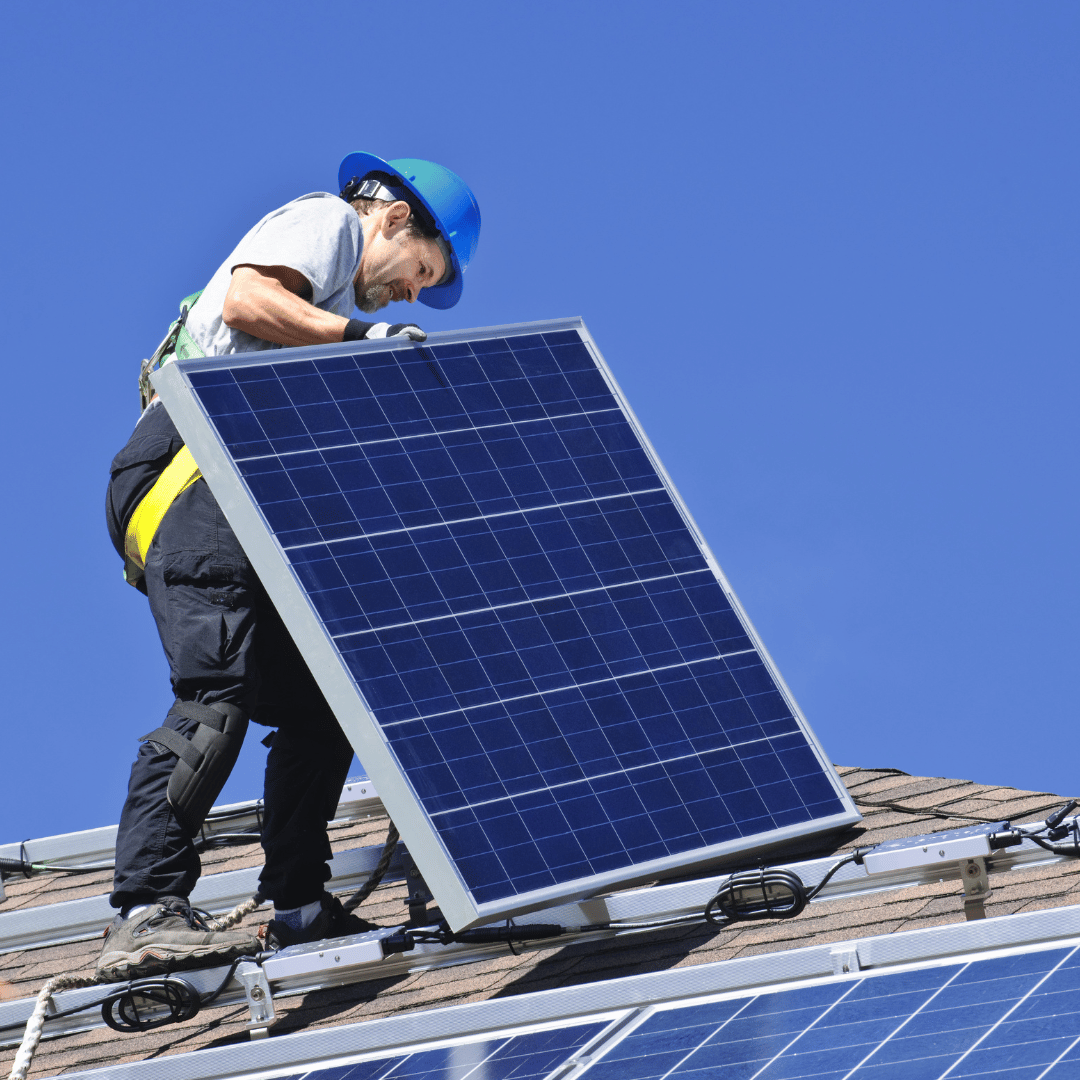 Large-scale solar array on an industrial flat roof under a cloudy sky, showcasing a professional Sygma Solar renewable energy project.
