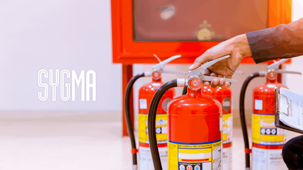 Row of red fire extinguishers symbolising BS 5839-1:2025 fire alarm standards and commercial fire safety compliance in the UK.