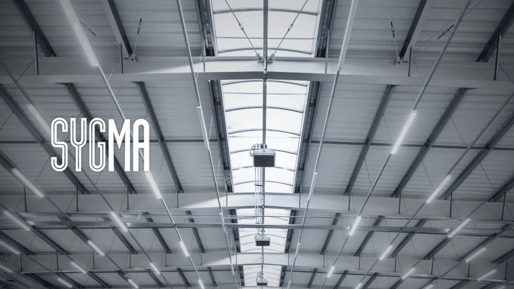 LED lighting installation in modern commercial warehouse ceiling with energy-efficient fixtures – Sygma Fire, Security & Electrical, South East England