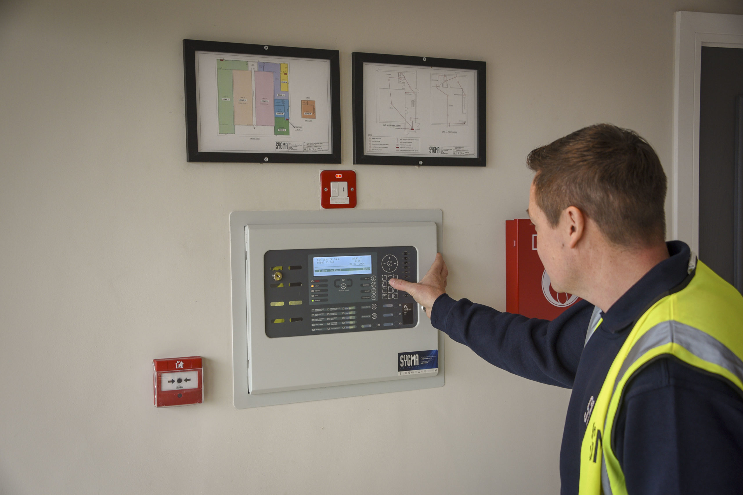 Sygma engineer installing a commercial fire alarm system