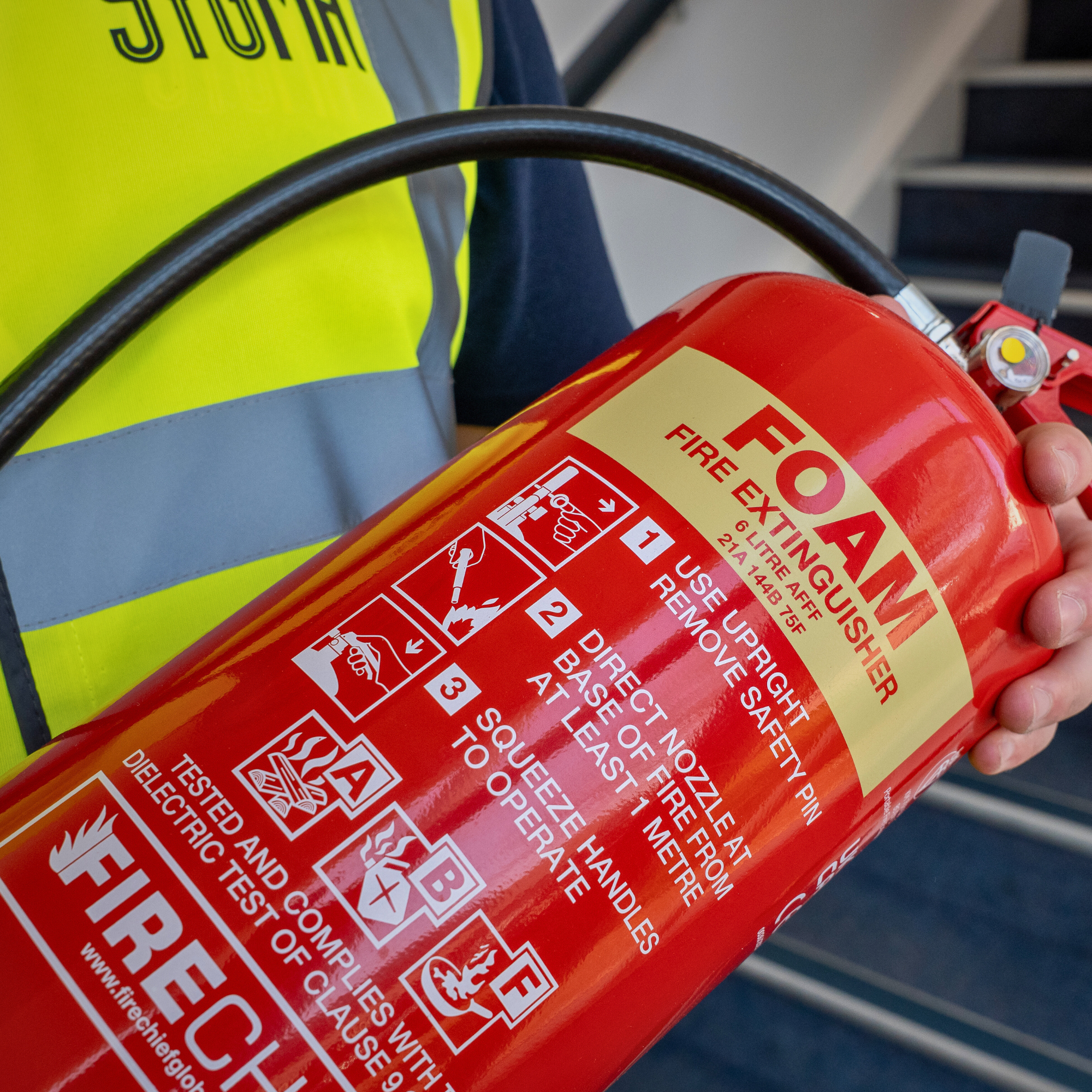 Sygma engineer inspecting fire extinguisher